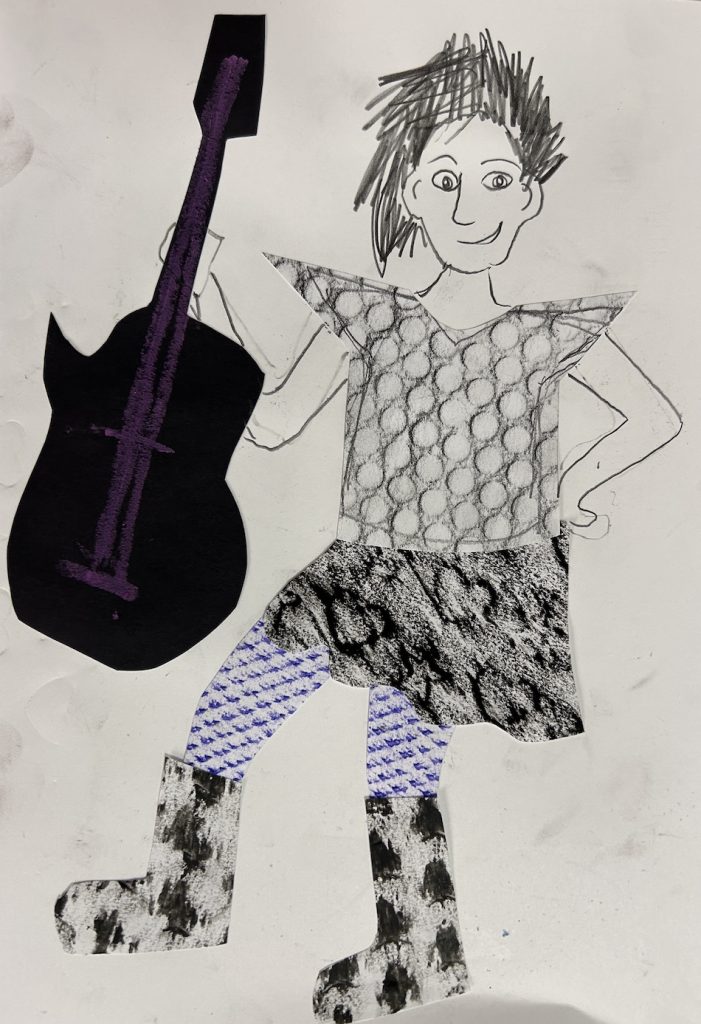 A mixed-media artwork of a hand-drawn person holding a guitar. The figure is created using pencil and paper cutouts with different textured rubbings for clothing elements—bubble wrap texture for the shirt, leaf or bark texture for the skirt, patterned blue for leggings, and spotted texture for boots. The guitar is cut from black paper with purple crayon detail.