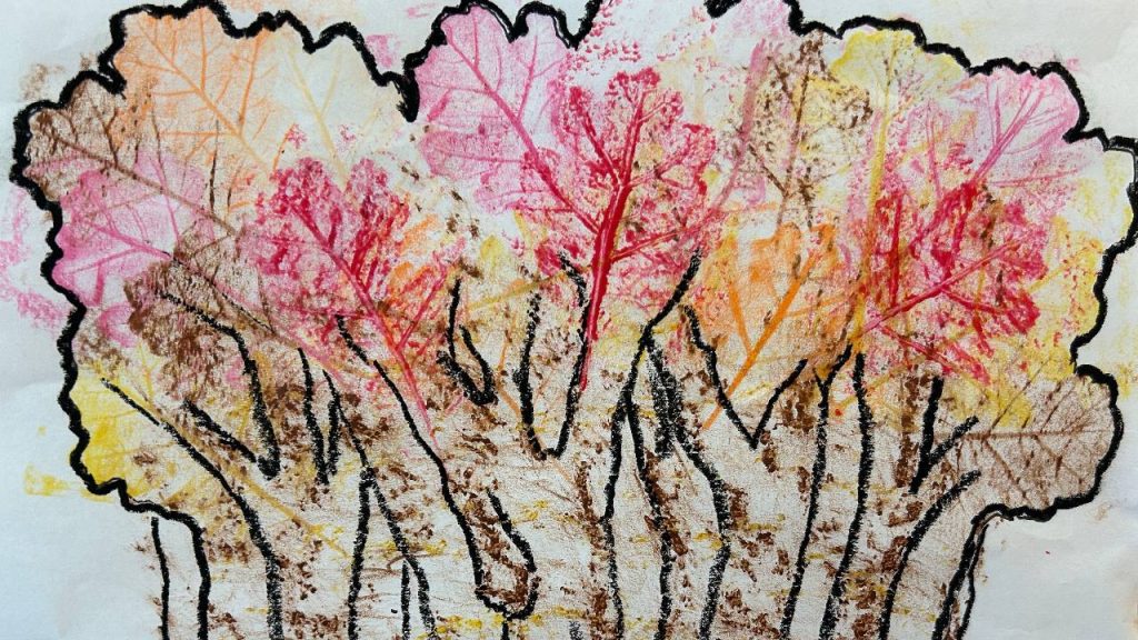A textured crayon and pastel drawing shows fall trees with brown trunks and overlapping red, orange, and yellow leaf rubbings.