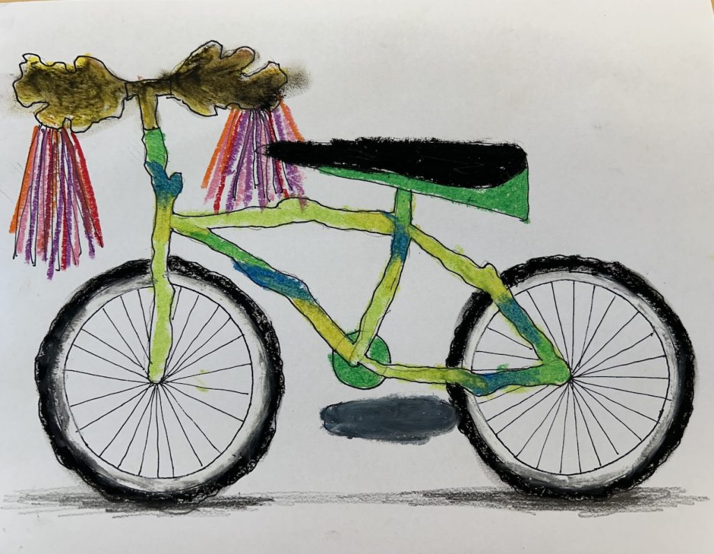 A colorful student artwork of a bicycle features a hand-drawn frame shaded with watercolor or crayon in greens, blues, and yellows. The handlebars include brown leaf-like shapes with pink and purple tassels, while the tires are detailed with black shading and radiating spokes.